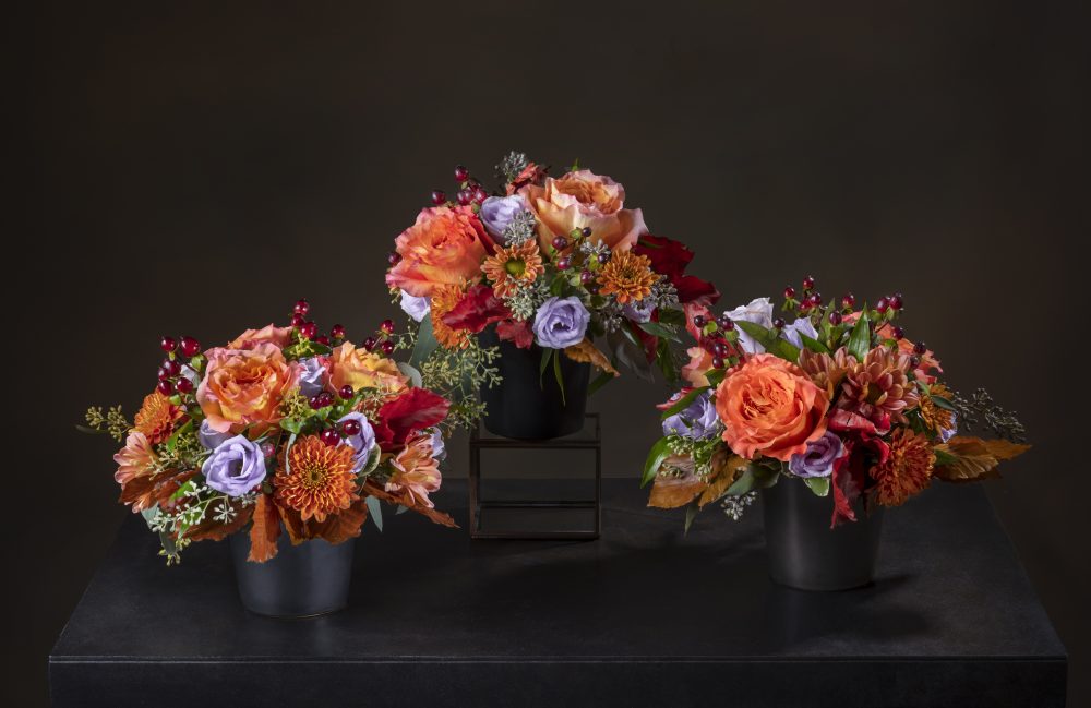 Striking fresh flowers in a round Thanksgiving centerpiece filled with bold autumn colors.