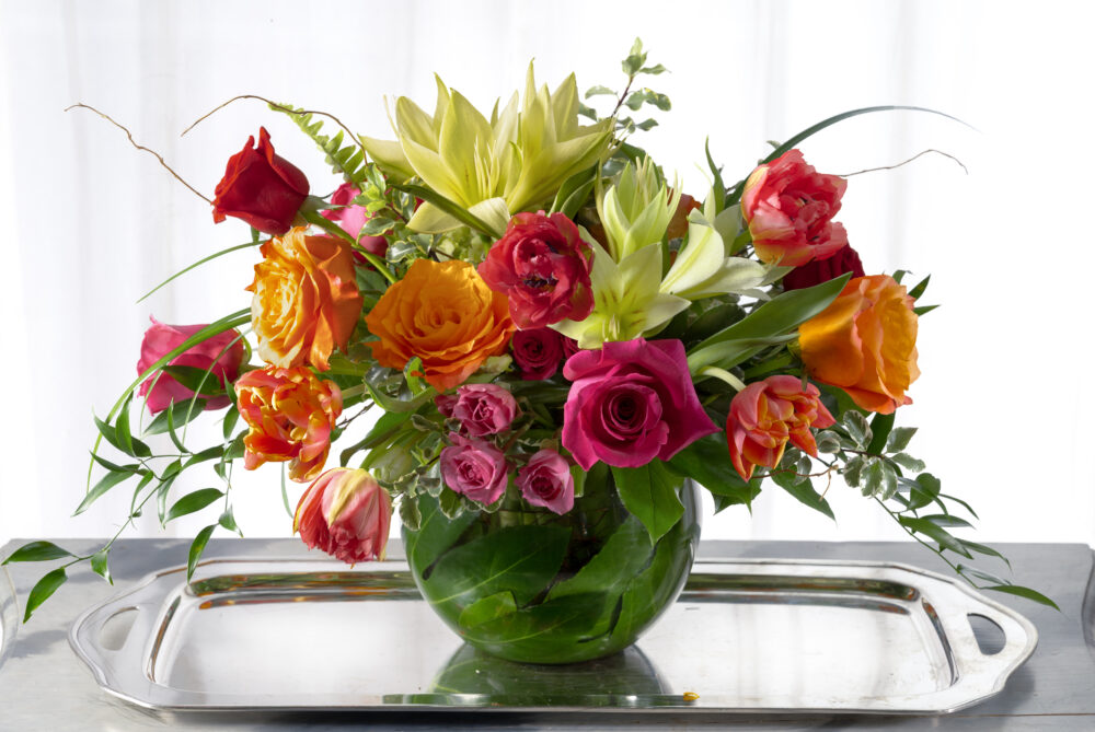 Simply splendid Valentine gift of a lush fresh flower arrangement with passion pink and coral roses, and bright spring flowers.