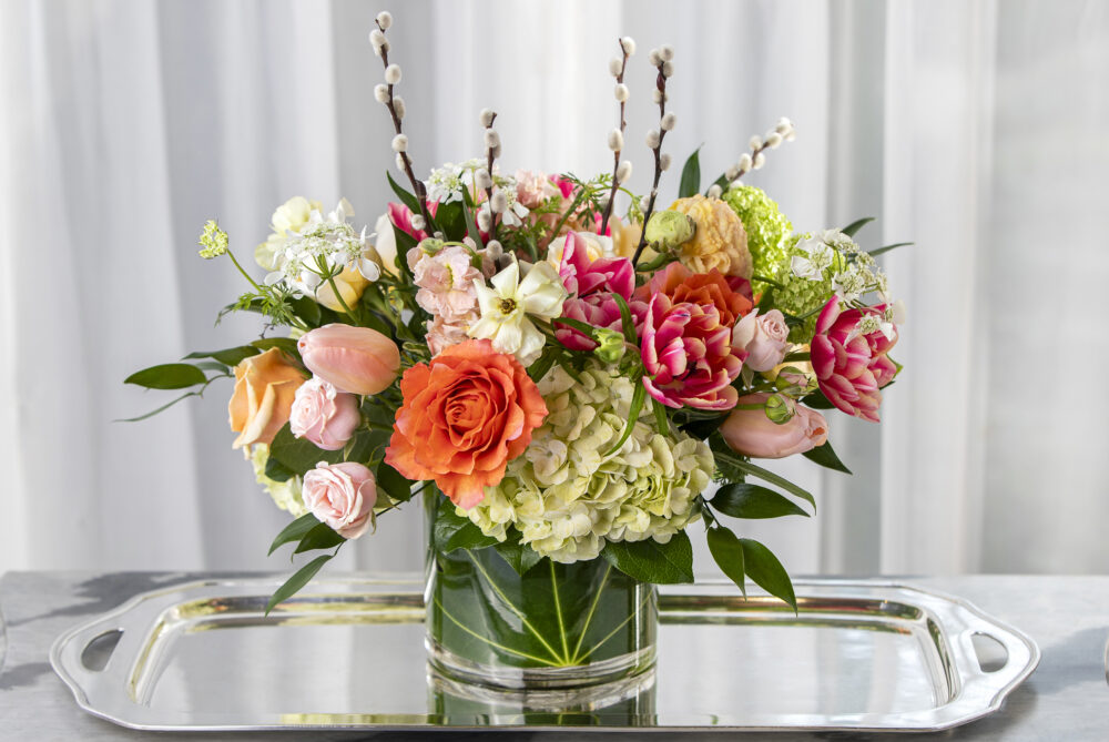 Gorgeous bright pink tulips with coral roses and accents of peach for a cheerful gift for Mother’s Day, delivered.