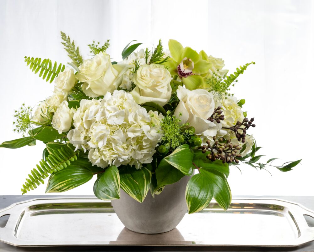 Lila is a white and green arrangement in a concrete newport pot.