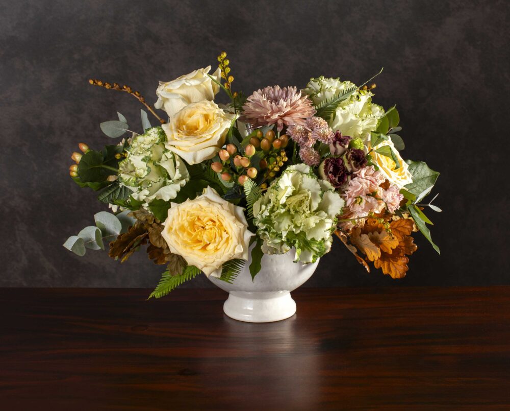 A Soft Pastel Autumn Floral Arrangement in Shades of blush, green and yellow with seasonal foliage and berries, delivered, thanksgiving.
