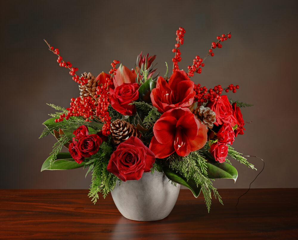 A lovely seasonal red rose and amaryllis flower arrangement with evergreen, magnolia and red ilex berries, delivered, holiday, Christmas