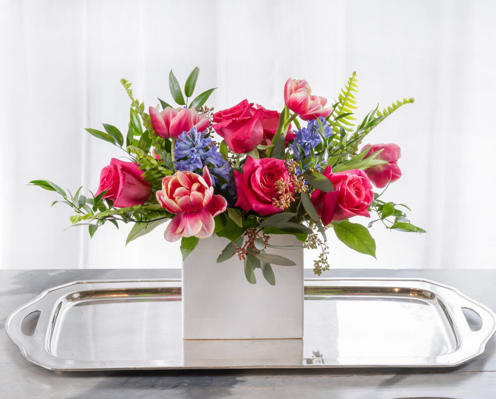 A bold and colorful, winter arrangement, roses, hyacinth, tulips, delivery