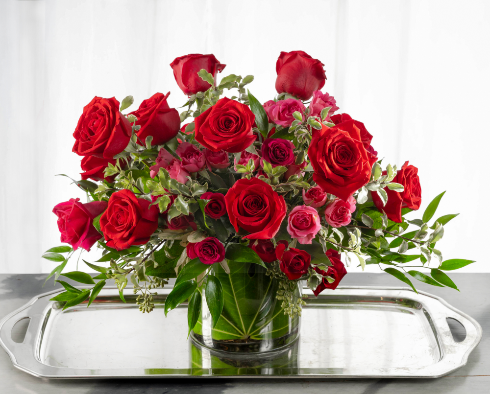 Alice is a vibrant red and pink valentine arrangement in a cylinder vase with a leaf wrap.