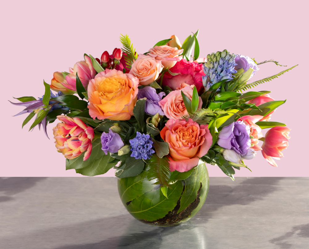 Bailey is a bright and cheerful spring floral arrangement for valentine’s day in shades of peach, pink and lavender.